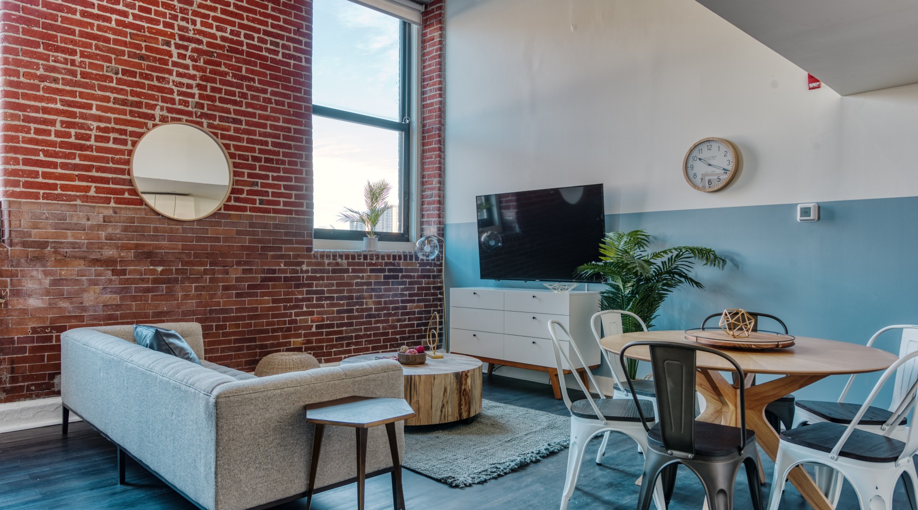 a room with a table chairs and a tv