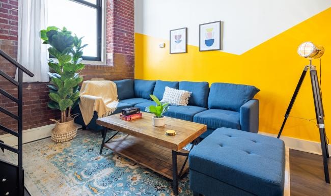 a living room with a blue couch and a table