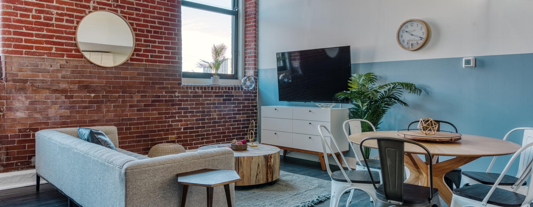 a room with a table chairs and a tv