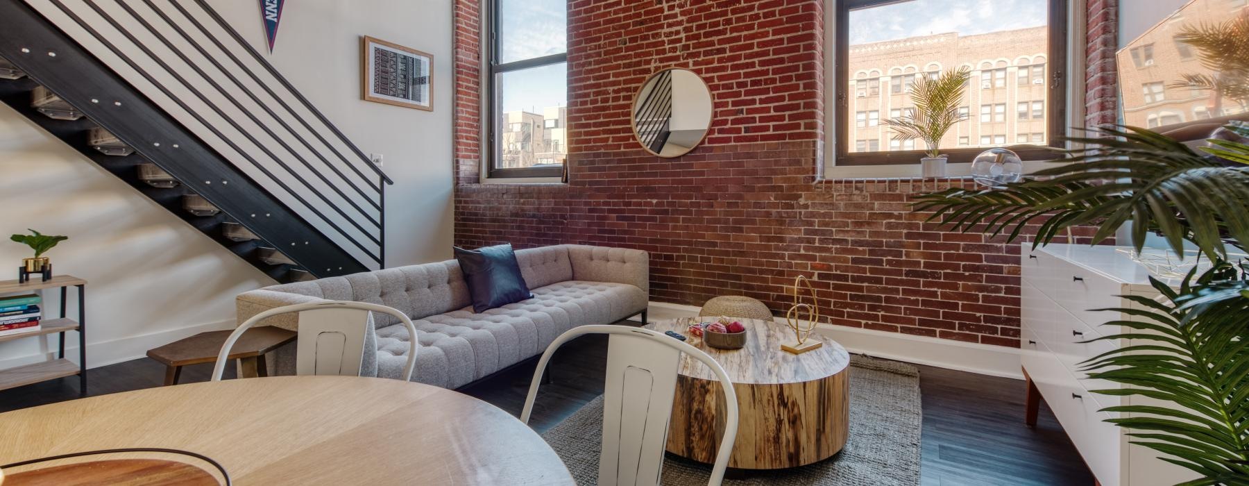 a living room with a brick wall
